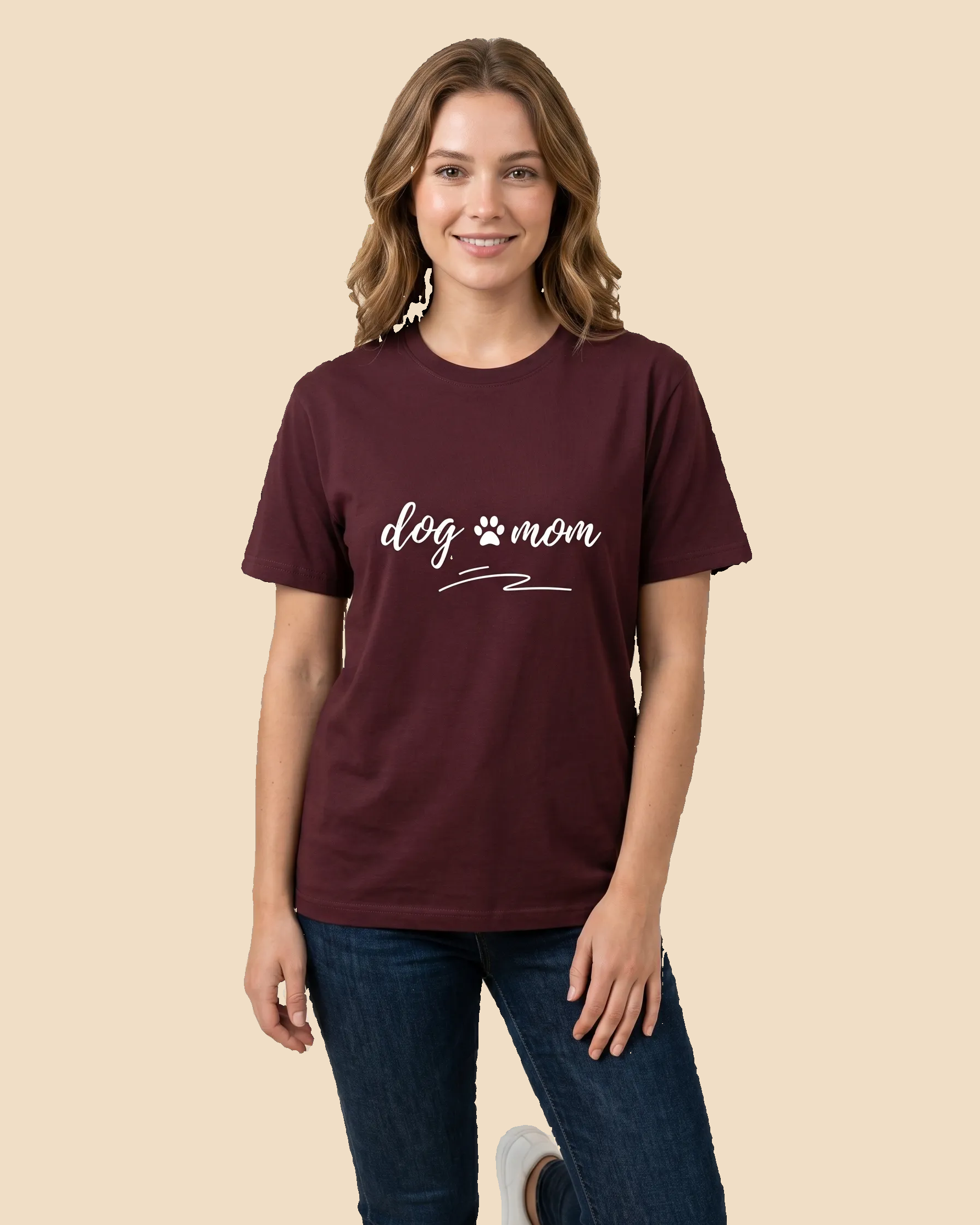 Woman wearing a maroon t-shirt with 'dog mom' text on a beige background