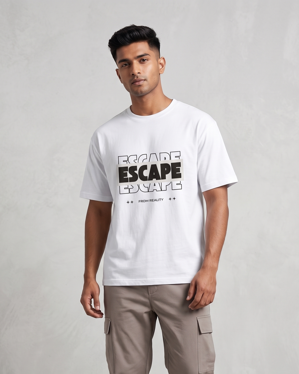Person wearing a white t-shirt with text and beige pants on a plain background