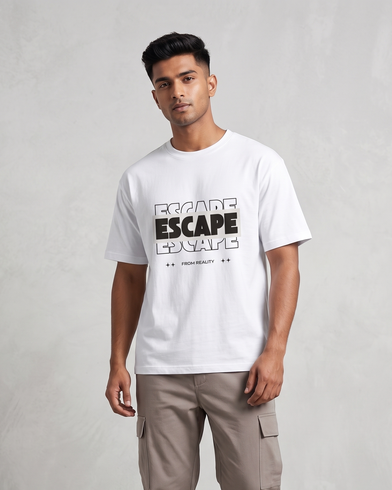 Person wearing a white t-shirt with text and beige pants on a plain background