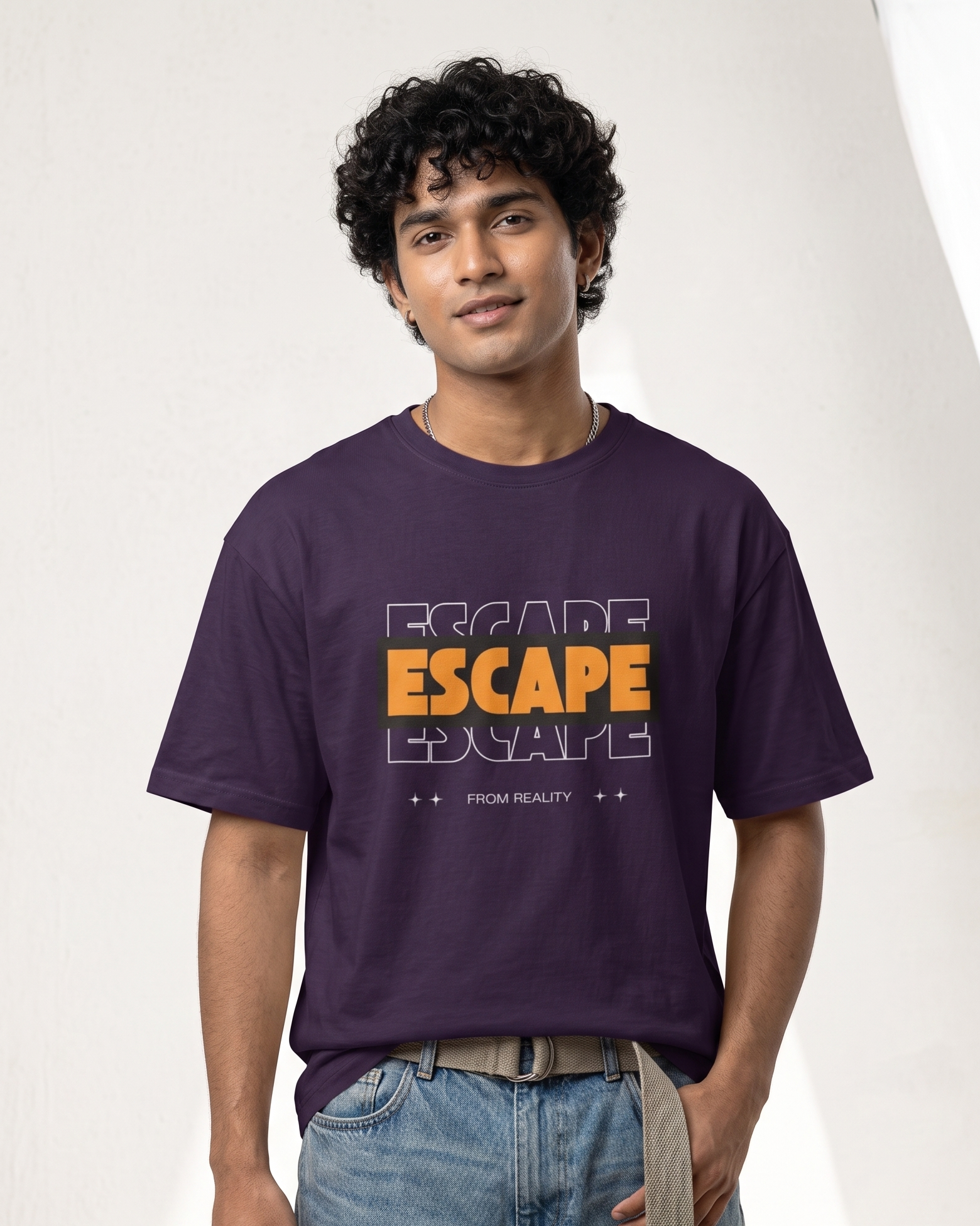 Person wearing a purple t-shirt with 'ESCAPE' text design on a plain background