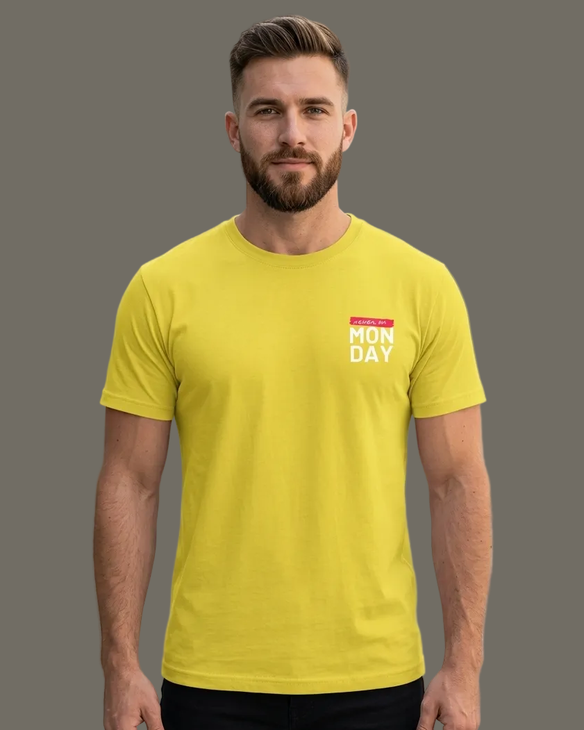 Man wearing a yellow t-shirt with text standing in an grey background
