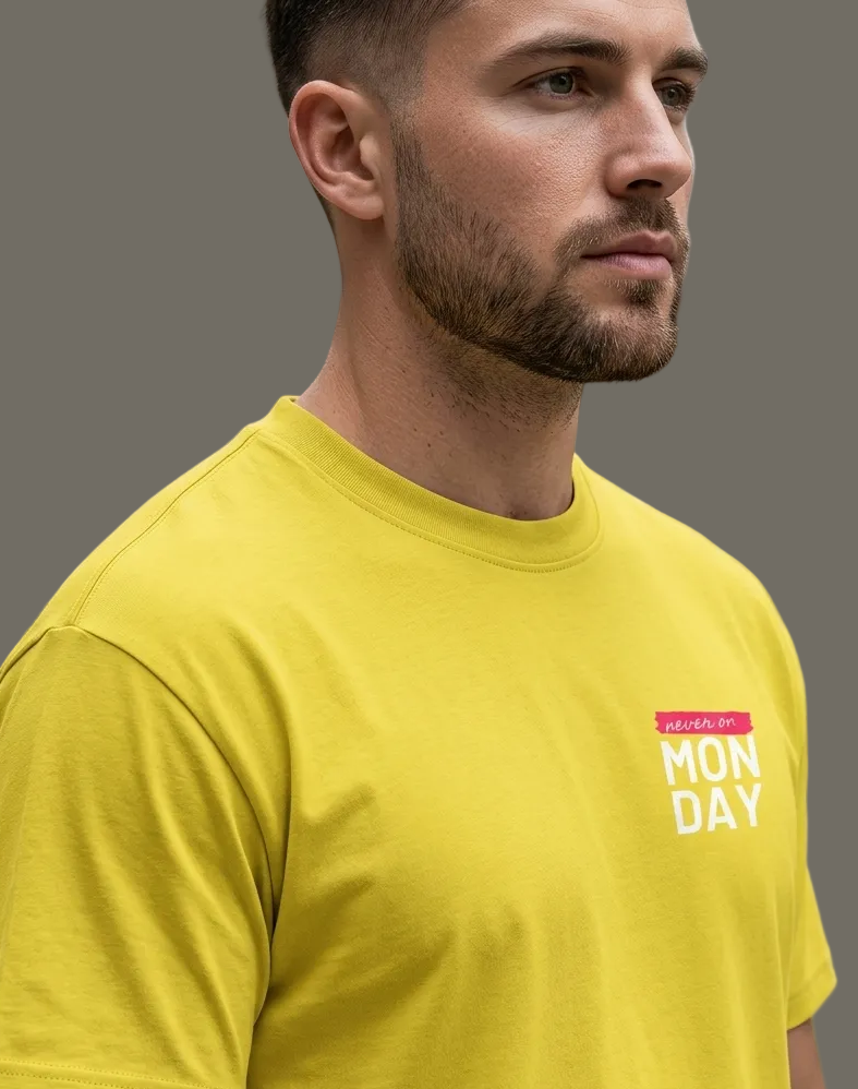 Man wearing a yellow t-shirt with text in a grey background