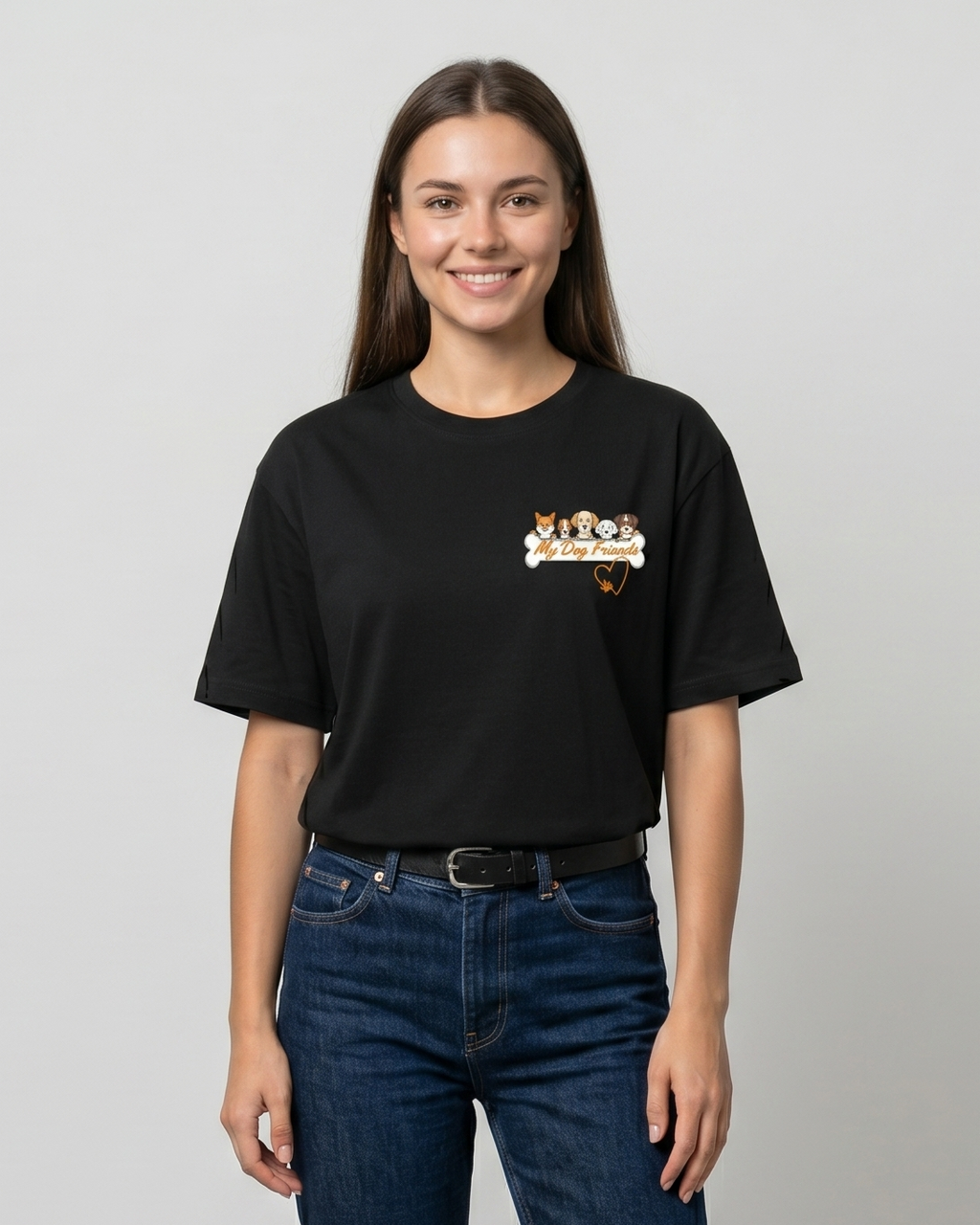 Person wearing a black t-shirt with a logo and blue jeans on a plain background