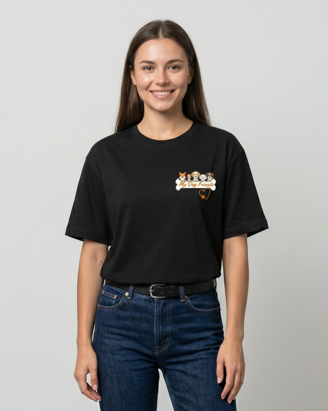 Person wearing a black t-shirt with a logo and blue jeans on a plain background