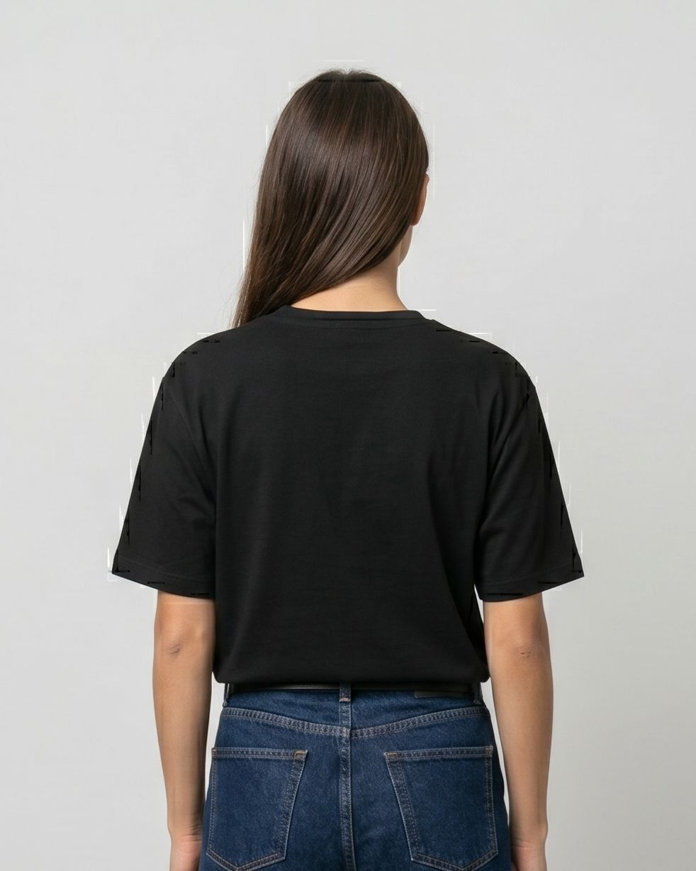 Person wearing blue jeans and a black t-shirt on a plain background