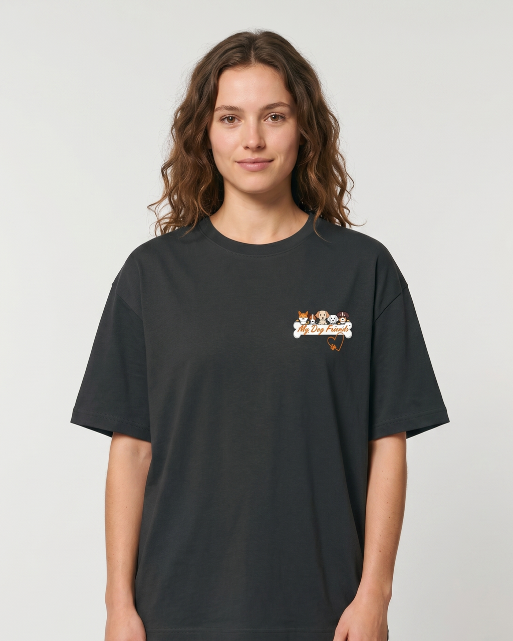 Person wearing a steel grey t-shirt with a small graphic on a plain background