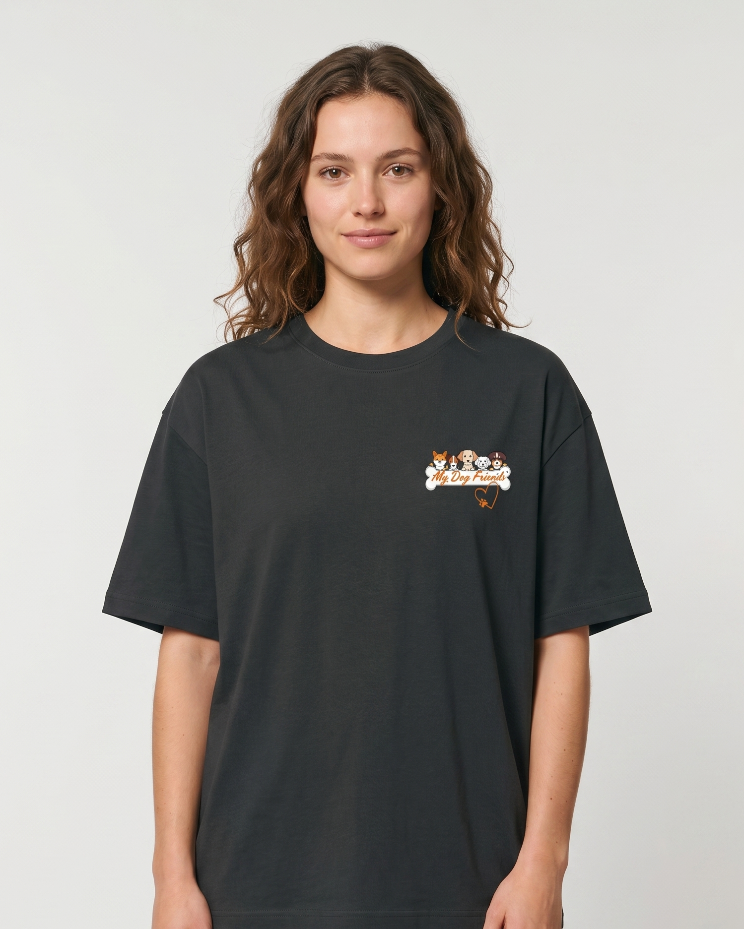 Person wearing a steel grey t-shirt with a small graphic on a plain background