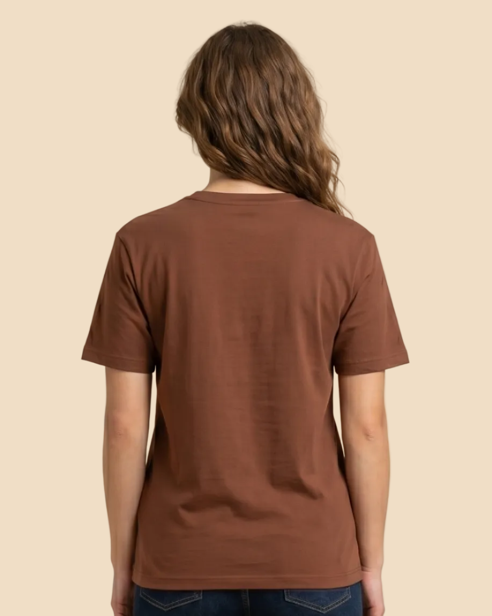 Person wearing a brown t-shirt and blue jeans on a beige background