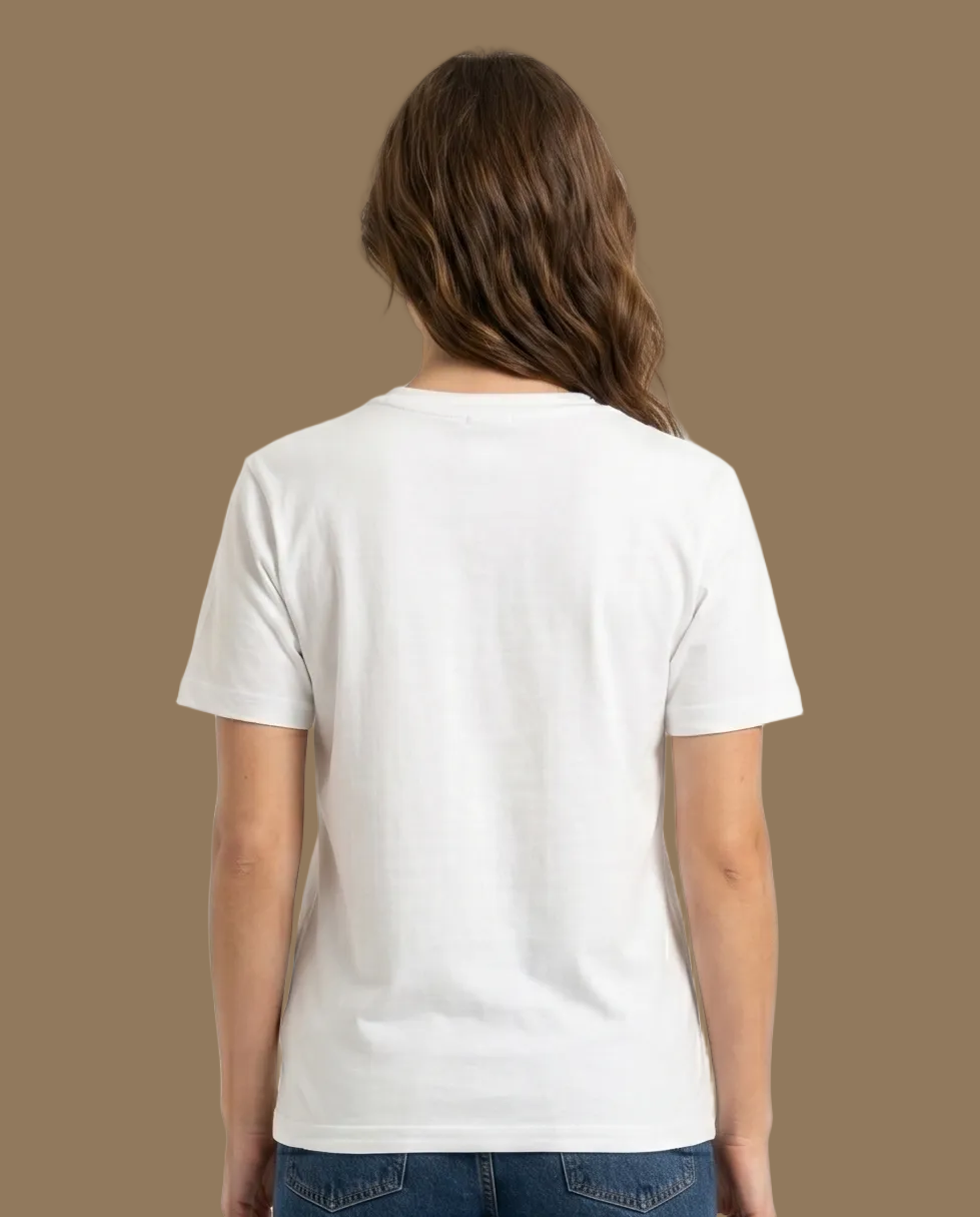 Person wearing a white t-shirt and blue jeans on a plain background