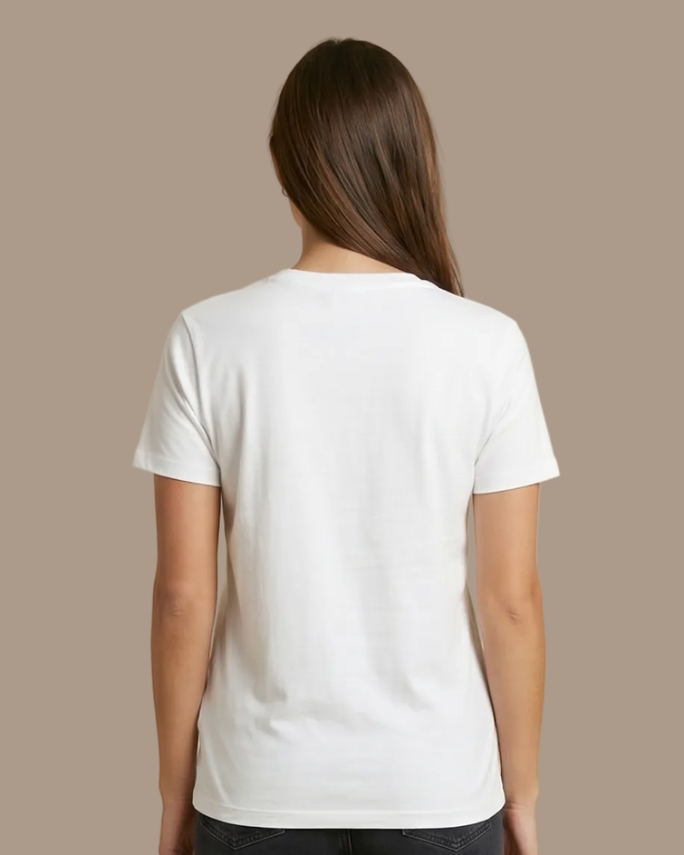 Person wearing a white t-shirt and dark jeans on a beige background