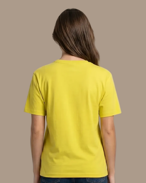 Person wearing a yellow t-shirt and blue jeans on a plane background