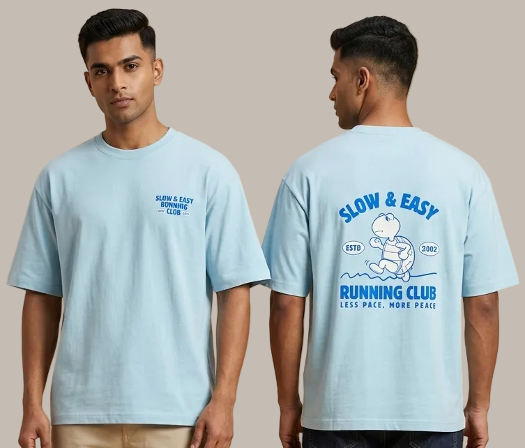 Two people wearing light blue t-shirts with a graphic design on a beige background
