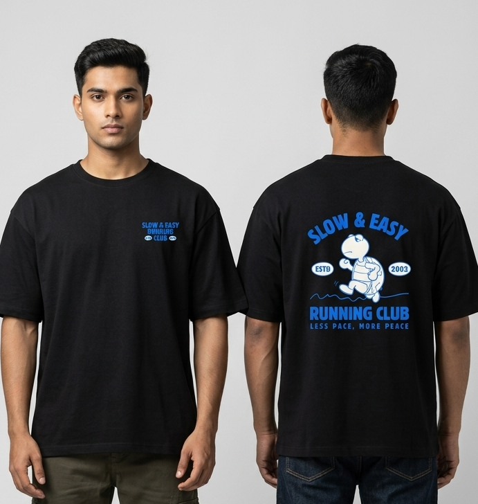 Person wearing a black t-shirt with text and graphics on a plain background