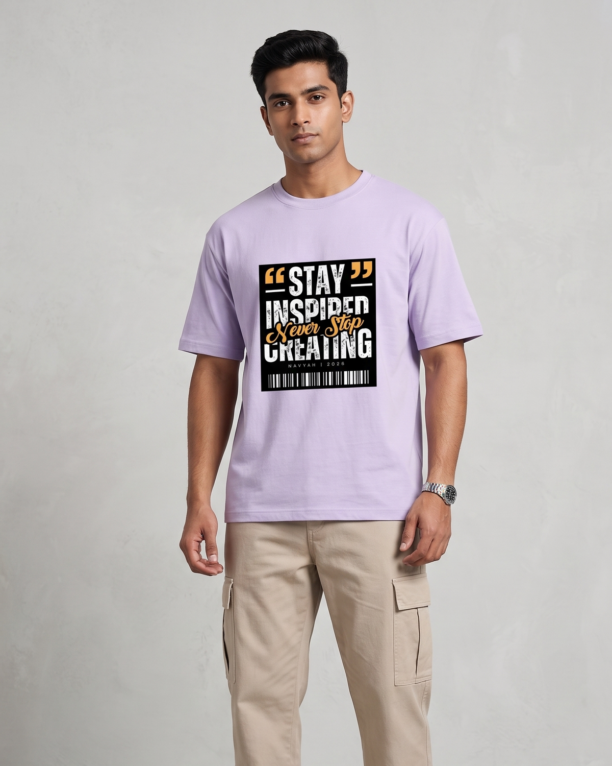Person wearing a lavender t-shirt with a motivational quote design on a plain background