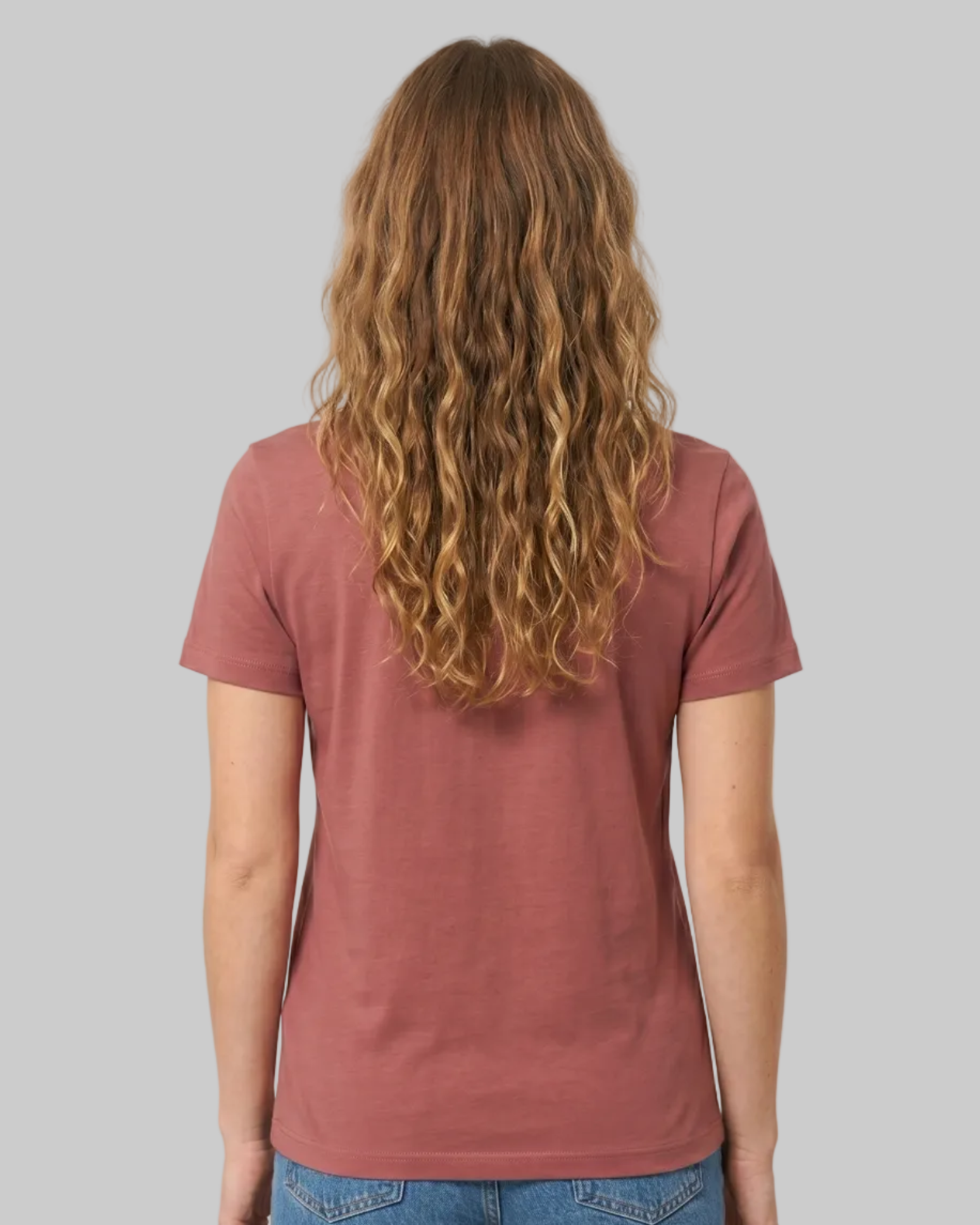 Person wearing a red t-shirt and blue jeans on a white background