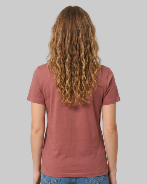 Person wearing a red t-shirt and blue jeans on a white background